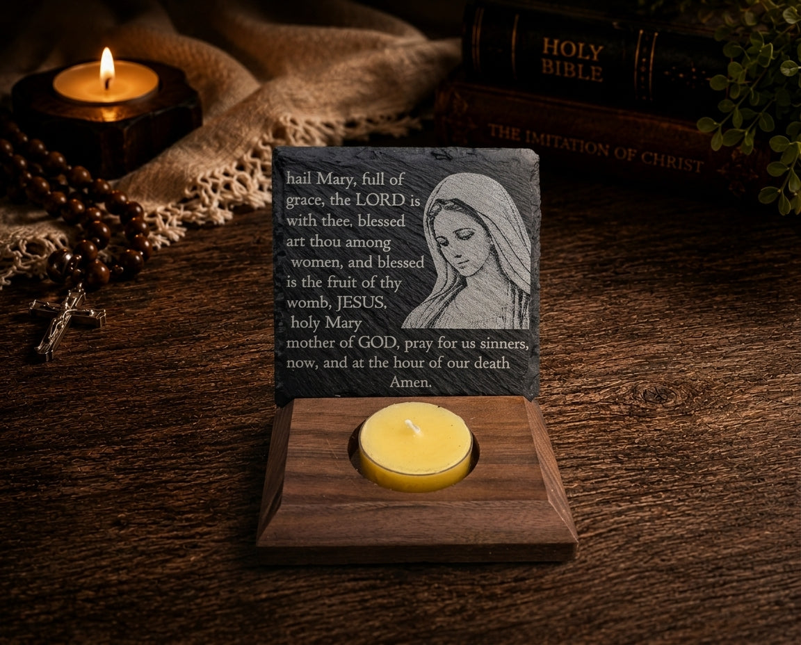 Artistic close-up of Blessed Virgin Mary Hail Mary engraving, natural slate, black walnut base, and beeswax candle.