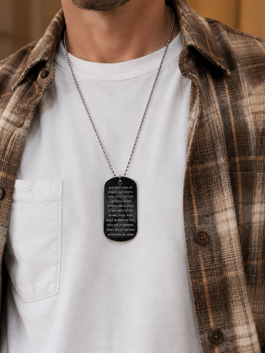 Hail Mary Catholic dog tag necklace worn with a white shirt and flannel