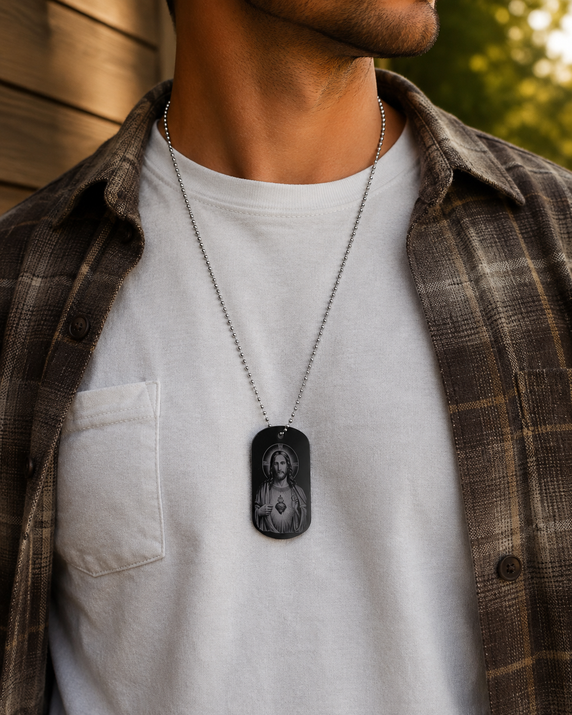 Person wearing Sacred Heart of Jesus dog tag necklace with Fatima Prayer